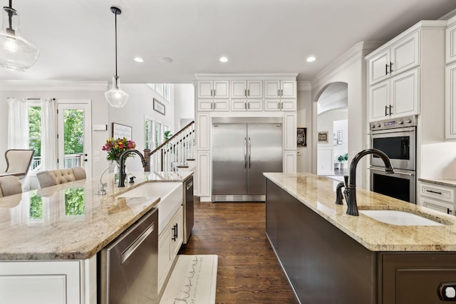 1234 Saddle Springs Dr, Thompsons Station, TN 37179 - kitchen with appliances with stainless steel finishes, a spacious island, a sink, ornamental molding, and recessed lighting