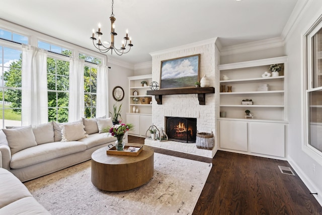 1234 Saddle Springs Dr, Thompsons Station, TN 37179 - living area featuring crown molding, dark wood-style floors, a chandelier, and a brick fireplace