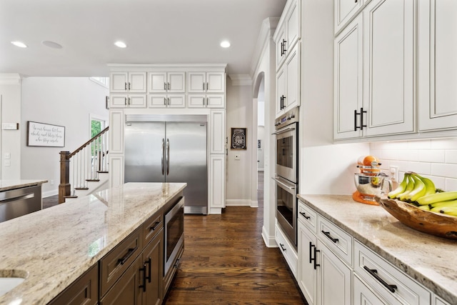 1234 Saddle Springs Dr, Thompsons Station, TN 37179 - kitchen with built in appliances, white cabinets, backsplash, recessed lighting, and dark brown cabinets