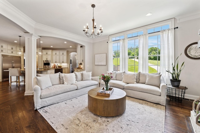 1234 Saddle Springs Dr, Thompsons Station, TN 37179 - living area featuring arched walkways, dark wood finished floors, ornate columns, a chandelier, and crown molding