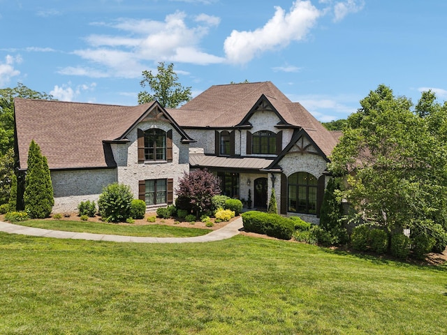 1234 Saddle Springs Dr, Thompsons Station, TN 37179 - french provincial home featuring a front yard, roof with shingles, and brick siding