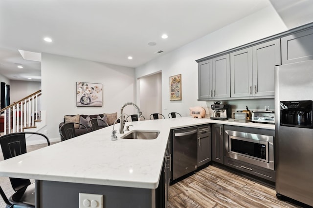 1234 Saddle Springs Dr, Thompsons Station, TN 37179 - kitchen with stainless steel appliances, a sink, a kitchen breakfast bar, a peninsula, and recessed lighting