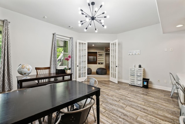 1234 Saddle Springs Dr, Thompsons Station, TN 37179 - dining area featuring french doors, a chandelier, light wood finished floors, and baseboards