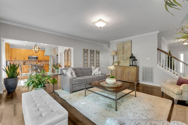 1154 Olde Cameron Ln, Franklin, TN 37067 - living room featuring crown molding, wood finished floors, baseboards, and stairway