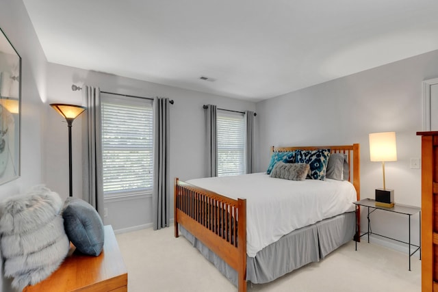 1154 Olde Cameron Ln, Franklin, TN 37067 - bedroom with light colored carpet, multiple windows, and baseboards