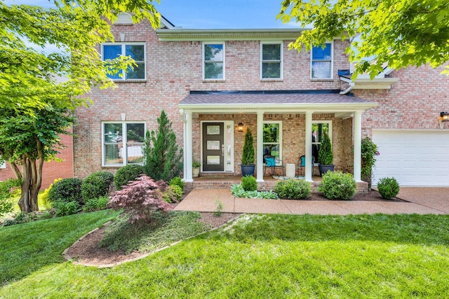 1154 Olde Cameron Ln, Franklin, TN 37067 - view of front of property with covered porch, a front yard, and brick siding
