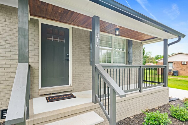 316 Bybee Branch Rd, Mcminnville, TN 37110 - doorway to property featuring covered porch and brick siding