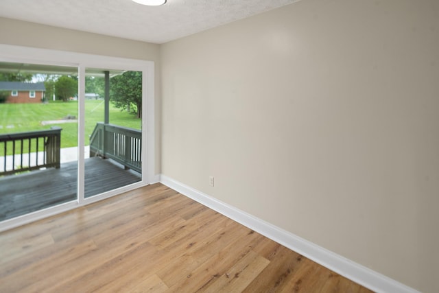 316 Bybee Branch Rd, Mcminnville, TN 37110 - spare room featuring baseboards, light wood-style flooring, and a textured ceiling