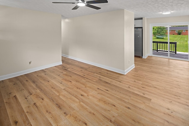 316 Bybee Branch Rd, Mcminnville, TN 37110 - spare room with ceiling fan, baseboards, light wood-style flooring, and a textured ceiling