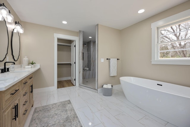 5935 S New Hope Rd, Hermitage, TN 37076 - full bathroom featuring double vanity, a shower stall, baseboards, a soaking tub, and a spacious closet