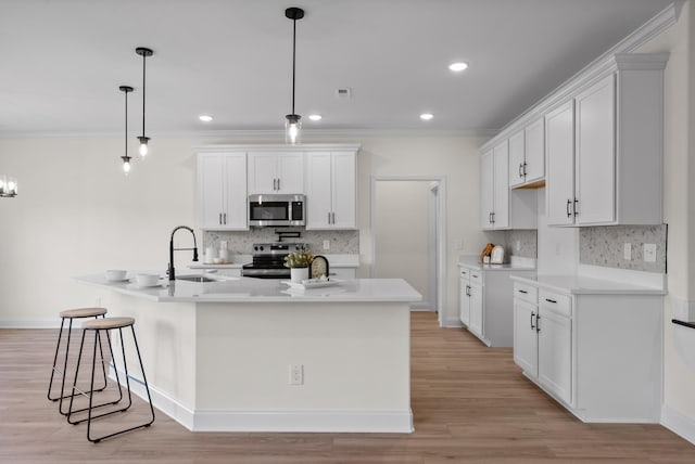 583 Pongracz Way, Clarksville, TN 37042 - kitchen featuring appliances with stainless steel finishes, a sink, tasteful backsplash, a large island, and white cabinetry