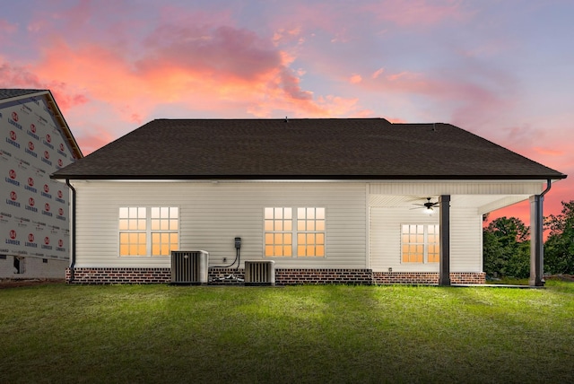 583 Pongracz Way, Clarksville, TN 37042 - back of property at dusk with a ceiling fan, a yard, central AC, and roof with shingles