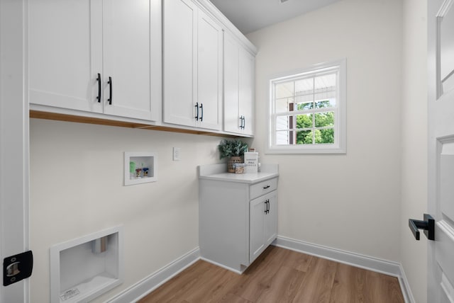 583 Pongracz Way, Clarksville, TN 37042 - laundry room with cabinet space, light wood-style flooring, hookup for a washing machine, and baseboards