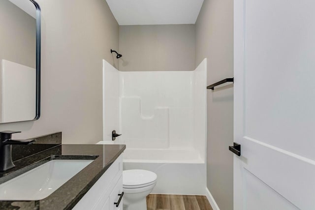 115 Carl Williams Rd, Crofton, KY 42217 - full bath featuring wood finished floors, vanity, toilet, shower / tub combination, and baseboards