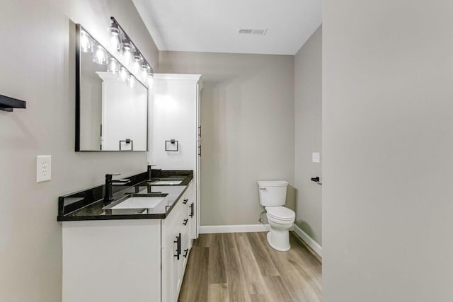 115 Carl Williams Rd, Crofton, KY 42217 - bathroom with toilet, wood finished floors, double vanity, and baseboards