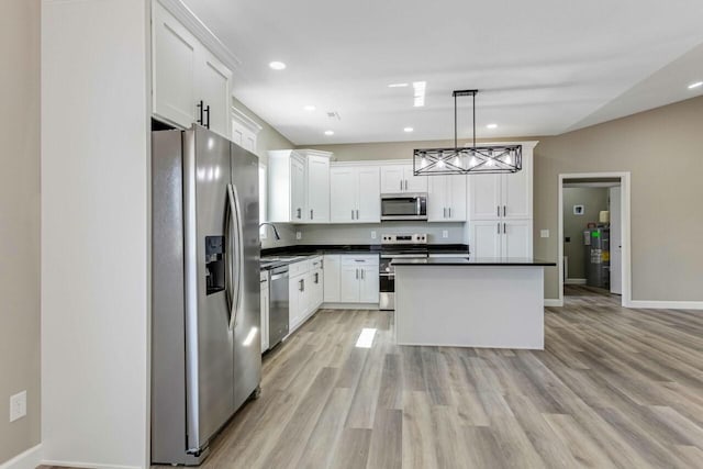 115 Carl Williams Rd, Crofton, KY 42217 - kitchen with stainless steel appliances, dark countertops, a sink, recessed lighting, and light wood-type flooring