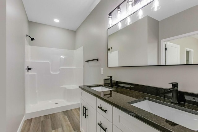 115 Carl Williams Rd, Crofton, KY 42217 - bathroom with wood finished floors, double vanity, a shower, and baseboards