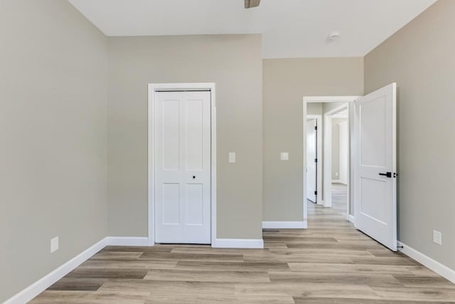 115 Carl Williams Rd, Crofton, KY 42217 - unfurnished bedroom featuring baseboards, light wood finished floors, and a closet