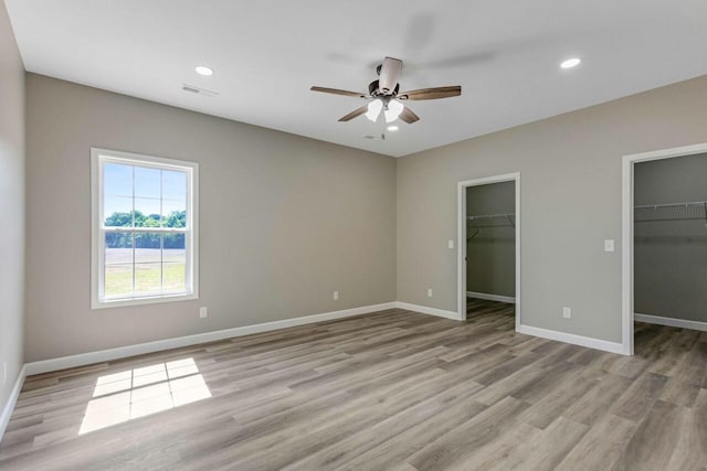 115 Carl Williams Rd, Crofton, KY 42217 - unfurnished bedroom featuring light wood finished floors, a spacious closet, baseboards, recessed lighting, and a ceiling fan