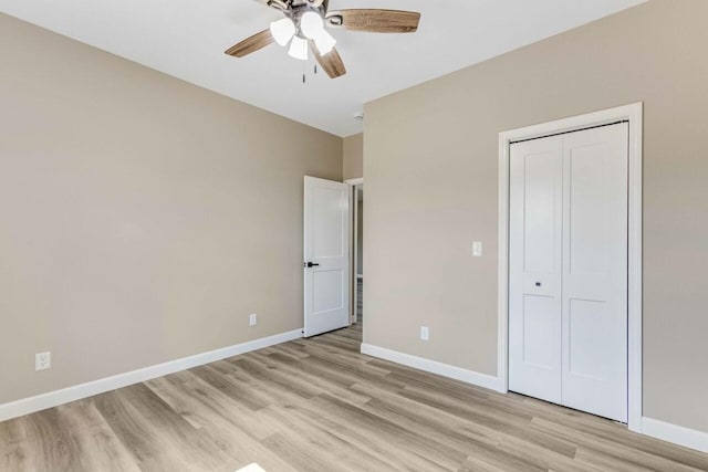 115 Carl Williams Rd, Crofton, KY 42217 - unfurnished bedroom with light wood-style floors, baseboards, a closet, and a ceiling fan