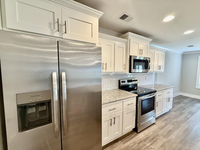 5608 Maples Retreat Dr, Murfreesboro, TN 37127 - kitchen featuring stainless steel appliances, light wood-type flooring, light stone counters, white cabinets, and tasteful backsplash
