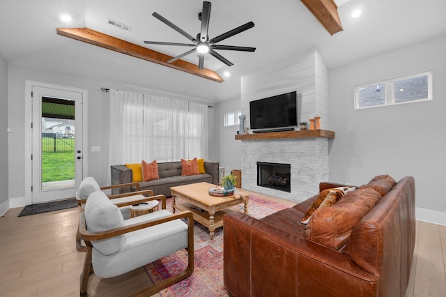 4010 Planters Trl, Mount Juliet, TN 37122 - living room with a ceiling fan, a stone fireplace, beamed ceiling, light wood-type flooring, and baseboards