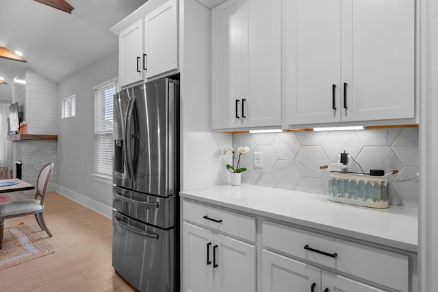 4010 Planters Trl, Mount Juliet, TN 37122 - kitchen featuring stainless steel fridge, light wood finished floors, vaulted ceiling, light countertops, and white cabinets