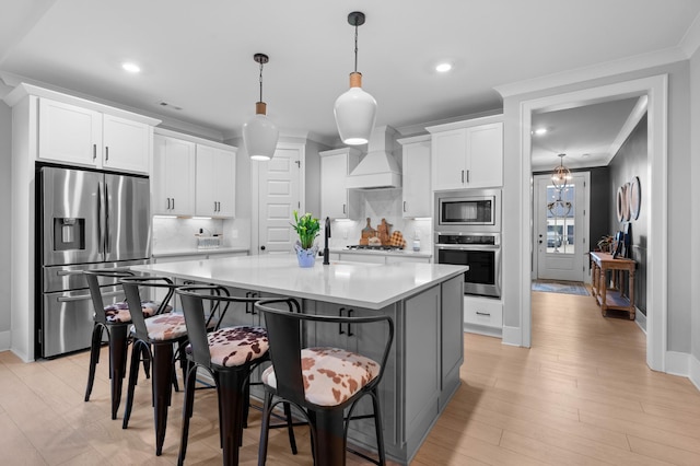 4010 Planters Trl, Mount Juliet, TN 37122 - kitchen with appliances with stainless steel finishes, premium range hood, backsplash, a center island with sink, and white cabinetry