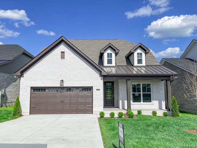 1110 Anson St, Gallatin, TN 37066 - view of front of house with brick siding, a standing seam roof, an attached garage, concrete driveway, and a front yard