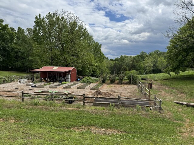 1829 Lobelville Hwy, Linden, TN 37096 - view of yard featuring an outdoor structure, an outbuilding, and a view of trees