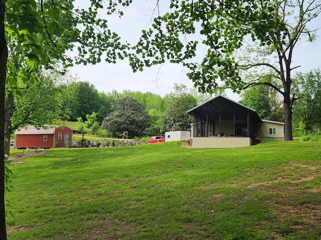 1829 Lobelville Hwy, Linden, TN 37096 - view of grassy yard with a sunroom and an outdoor structure