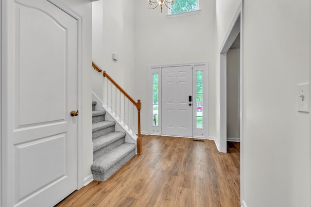 3471 Esquire Dr, Murfreesboro, TN 37130 - entrance foyer featuring a chandelier, healthy amount of natural light, light wood-style floors, stairway, and a towering ceiling
