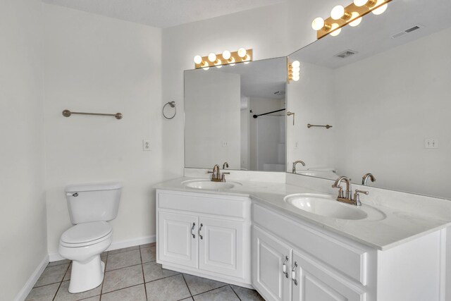 3471 Esquire Dr, Murfreesboro, TN 37130 - full bath with tile patterned floors, double vanity, toilet, and baseboards