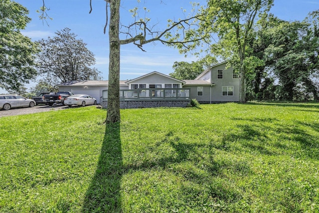 1151 Baker And Hearn Cir, Chickamauga, GA 30707 - view of front facade with a front lawn, a wooden deck, driveway, and a garage