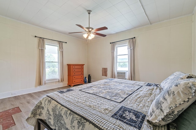 1672 Globe Rd, Lewisburg, TN 37091 - bedroom featuring wood finished floors, multiple windows, ornamental molding, cooling unit, and baseboards