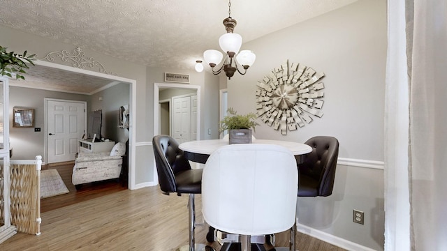 813 Chaney Woods Dr, La Vergne, TN 37086 - dining space featuring a chandelier, wood finished floors, baseboards, and a textured ceiling