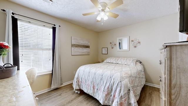 813 Chaney Woods Dr, La Vergne, TN 37086 - bedroom with light wood-style flooring, multiple windows, baseboards, a textured ceiling, and a ceiling fan