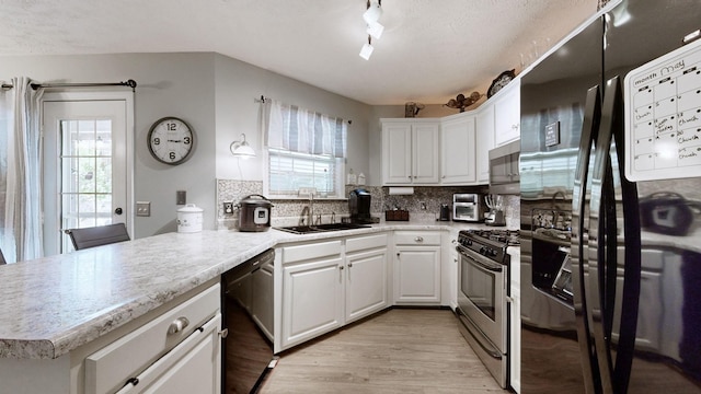 813 Chaney Woods Dr, La Vergne, TN 37086 - kitchen featuring black appliances, a sink, healthy amount of natural light, and white cabinetry