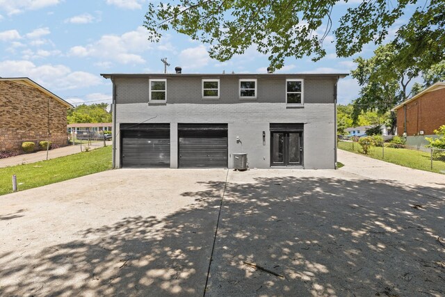 373 Kingview Dr, Nashville, TN 37218 - view of front of house with concrete driveway, a garage, brick siding, and central AC unit
