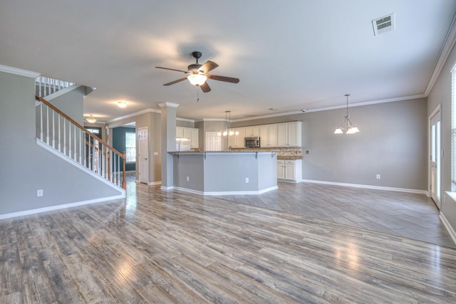 21 Cypress Hill Dr, Lebanon, TN 37087 - unfurnished living room featuring a ceiling fan, stairs, light wood finished floors, baseboards, and ornamental molding