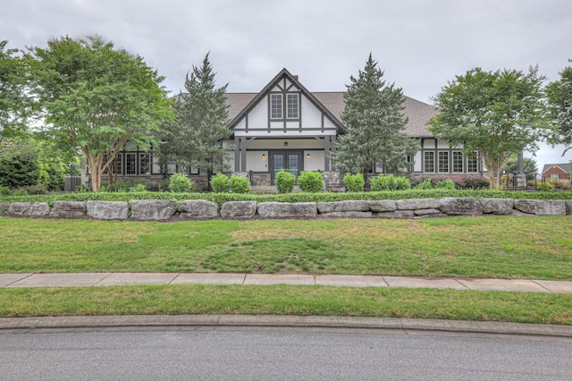 21 Cypress Hill Dr, Lebanon, TN 37087 - tudor-style house featuring stucco siding, french doors, a front yard, and stone siding