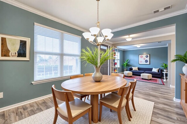 21 Cypress Hill Dr, Lebanon, TN 37087 - dining space with light wood-type flooring, ornamental molding, baseboards, and a chandelier