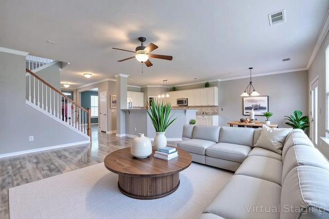 21 Cypress Hill Dr, Lebanon, TN 37087 - living room featuring light wood-style flooring, ceiling fan, stairs, healthy amount of natural light, and ornamental molding