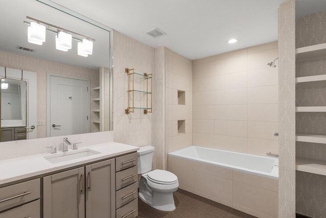 1212 Laurel St Unit 2005, Nashville, TN 37203 - full bathroom with vanity, toilet, tiled shower / bath, tile patterned flooring, and wallpapered walls