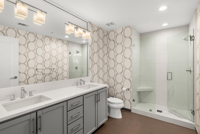 1212 Laurel St Unit 2005, Nashville, TN 37203 - bathroom featuring toilet, a shower stall, double vanity, wallpapered walls, and recessed lighting