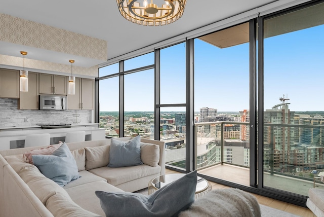 1212 Laurel St Unit 2005, Nashville, TN 37203 - living room featuring expansive windows, a view of city, light wood-type flooring, and a chandelier