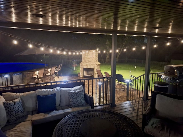 1006 Indian Trl, Castalian Springs, TN 37031 - patio at night with an outdoor living space with a fireplace, a patio, and a fenced backyard
