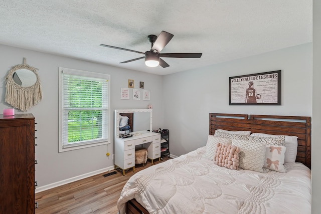 1006 Indian Trl, Castalian Springs, TN 37031 - bedroom featuring wood finished floors, baseboards, ceiling fan, and a textured ceiling