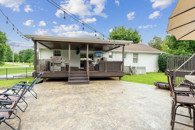 1006 Indian Trl, Castalian Springs, TN 37031 - rear view of property featuring brick siding, a patio area, a deck, and central AC unit