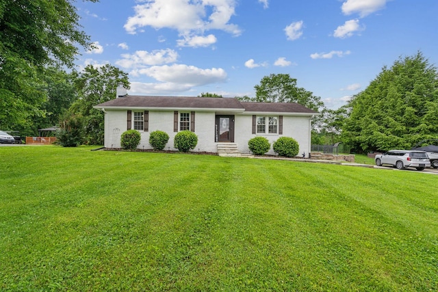 1006 Indian Trl, Castalian Springs, TN 37031 - single story home featuring a front yard, a chimney, entry steps, and brick siding
